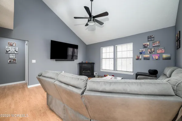 a bed sitting in a spacious bedroom next to a window