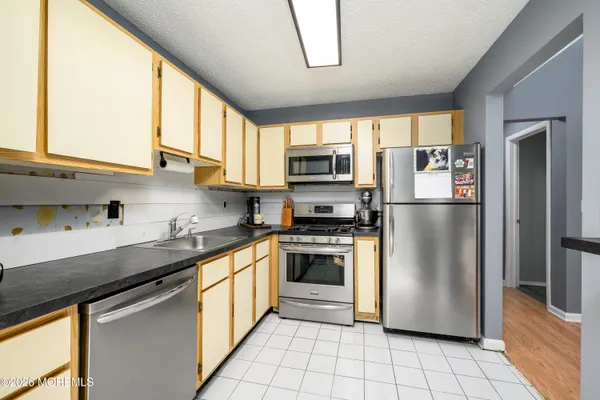 a view of a bedroom with furniture and window