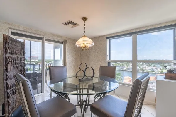 a view of a dining room with furniture large windows and wooden floor