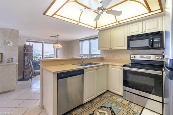 a kitchen with stainless steel appliances a stove microwave and a refrigerator