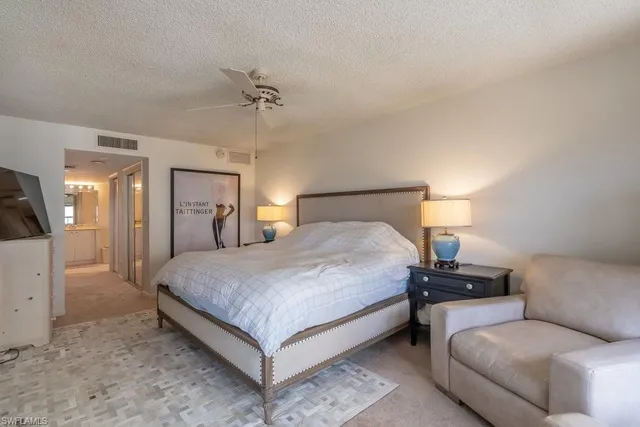 a bedroom with a bed and lamp