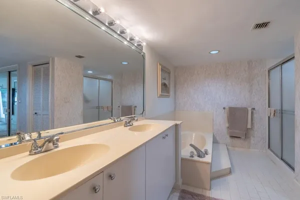 a bathroom with a sink double vanity and a toilet