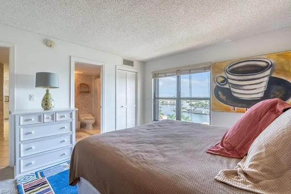 a bedroom with a bed and a chair