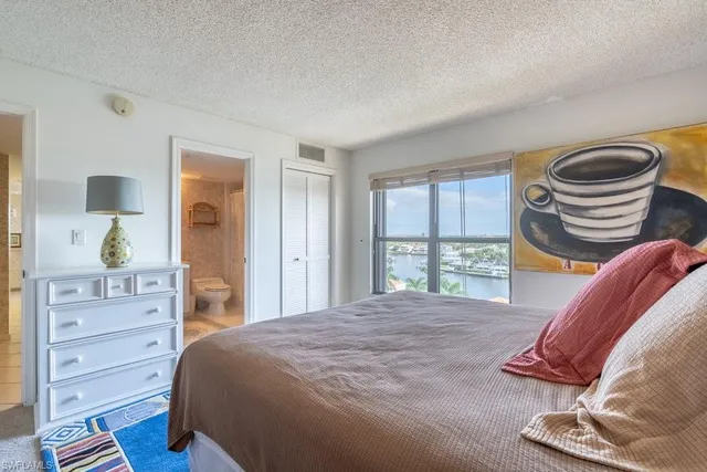 a bedroom with a bed and a chair