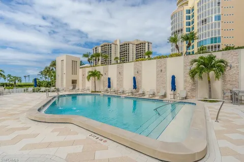 a view of swimming pool with outdoor seating and plants