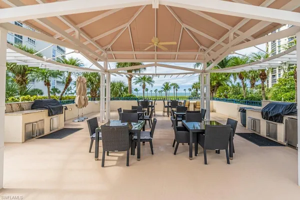 a view of a patio with a table and chairs under an umbrella