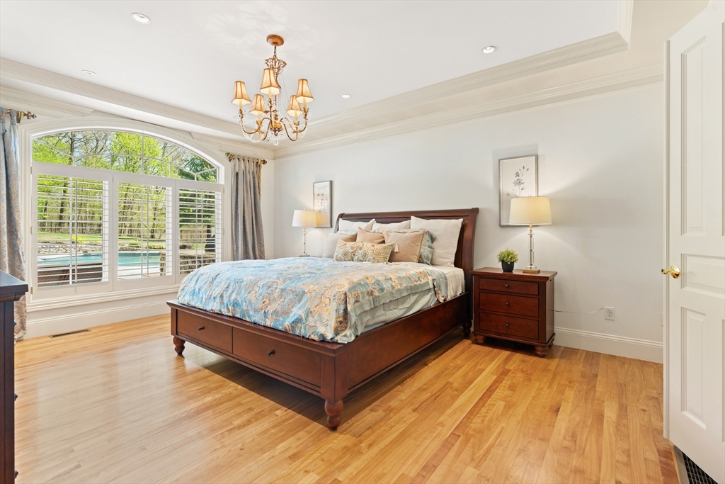 46 Porter Road Andover, MA 01810 - Photo 21 of 42 a bedroom with a large bed chandelier and a window