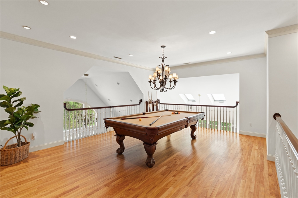 46 Porter Road Andover, MA 01810 - Photo 30 of 42 a room with wooden floor pool table and a chandelier
