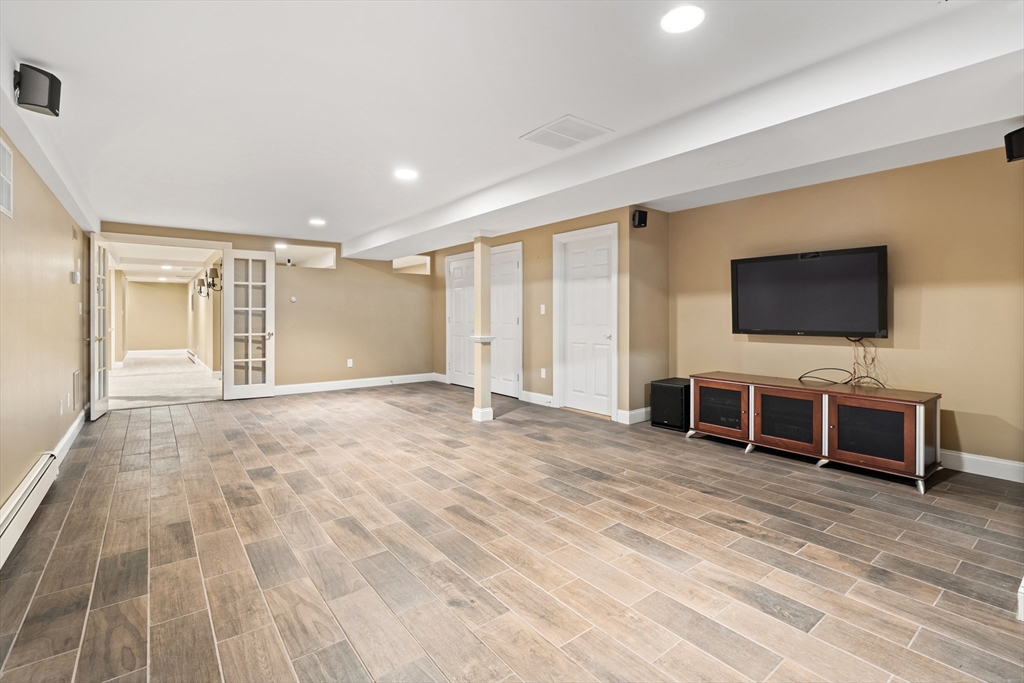 46 Porter Road Andover, MA 01810 - Photo 31 of 42 a view of a livingroom with furniture and a flat screen tv