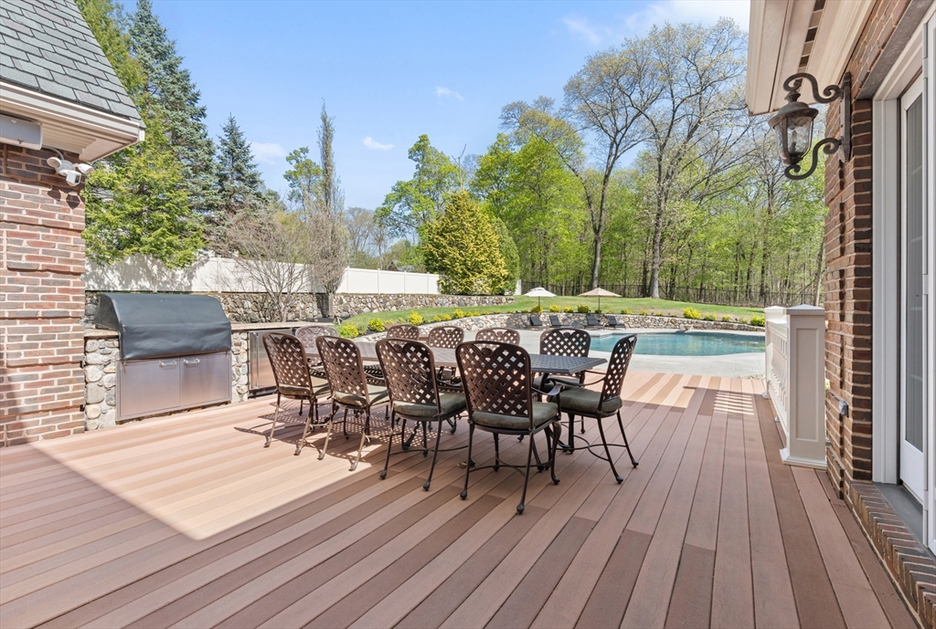 46 Porter Road Andover, MA 01810 - Photo 35 of 42 a view of a patio with table and chairs and potted plants with wooden floor and fence