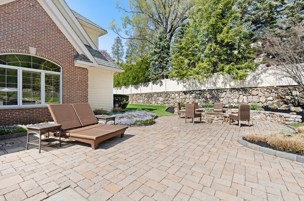46 Porter Road Andover, MA 01810 - Photo 38 of 42 a view of a patio with a table and chairs and potted plants