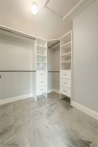 an empty room with a ceiling fan and window