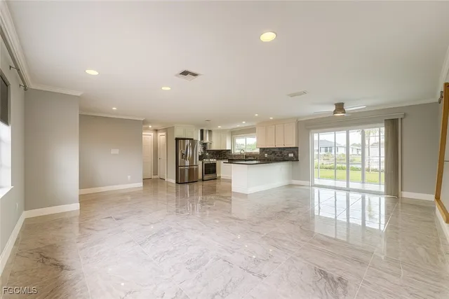 a view of kitchen with refrigerator and window