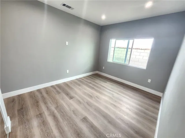 wooden floor in an empty room with a mirror