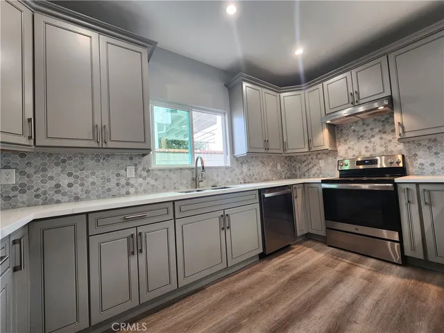 a view of a refrigerator in kitchen and an empty room