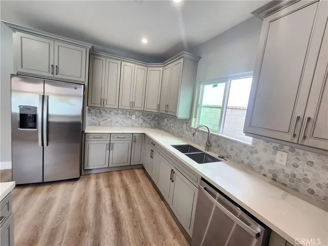 an empty room with wooden floor and entrance