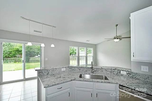 a kitchen with granite countertop a sink and a window