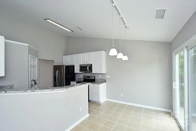 a kitchen with kitchen island a sink stainless steel appliances and cabinets