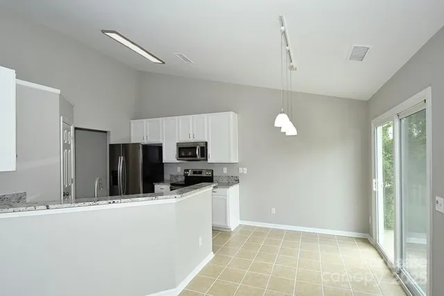 a kitchen with stainless steel appliances a refrigerator sink and microwave