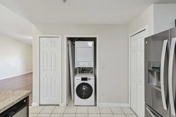 a kitchen with granite countertop a refrigerator and a sink