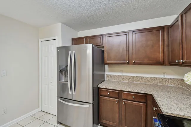 a kitchen with a refrigerator and cabinets