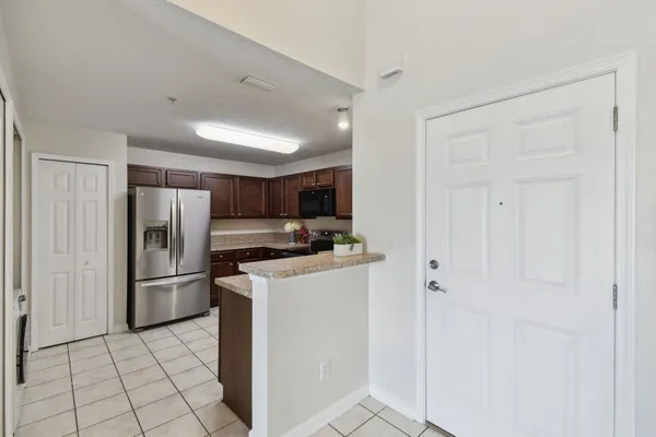 a kitchen with stainless steel appliances a refrigerator and a stove top oven