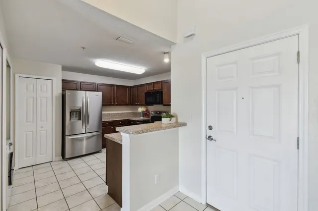 a kitchen with stainless steel appliances a refrigerator and a stove top oven