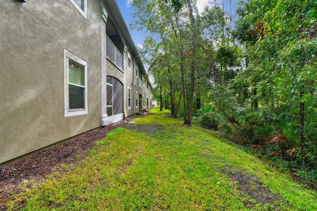 an aerial view of a house with garden space and street view