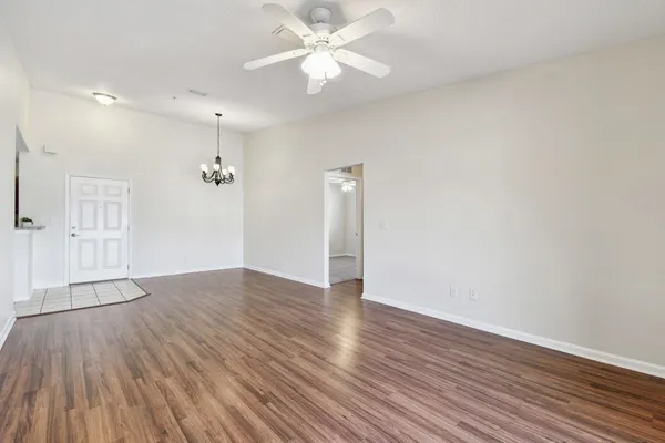 a view of a room with wooden floors and chandelier