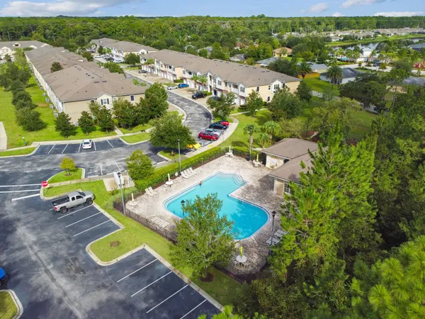 an aerial view of a house with garden space and street view