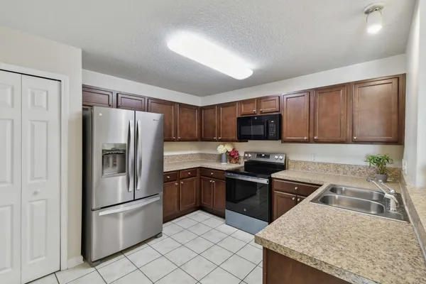 a kitchen with a sink stove and refrigerator