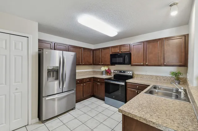 a kitchen with a sink stove and refrigerator