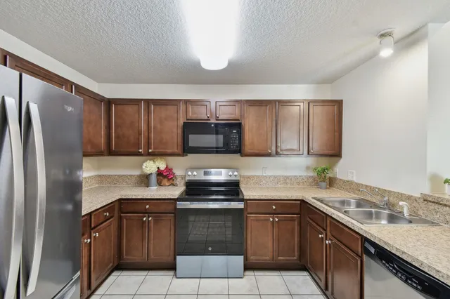 a kitchen with a sink appliances and cabinets