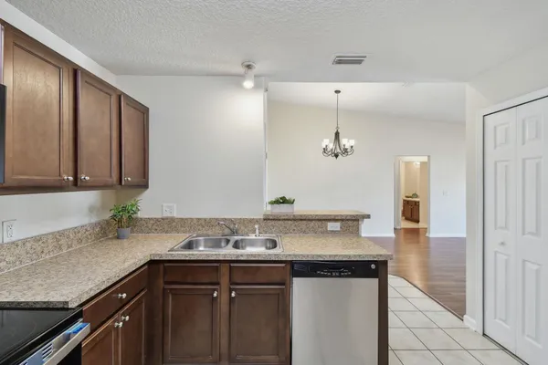 a sink and a washer dryer with a mirror