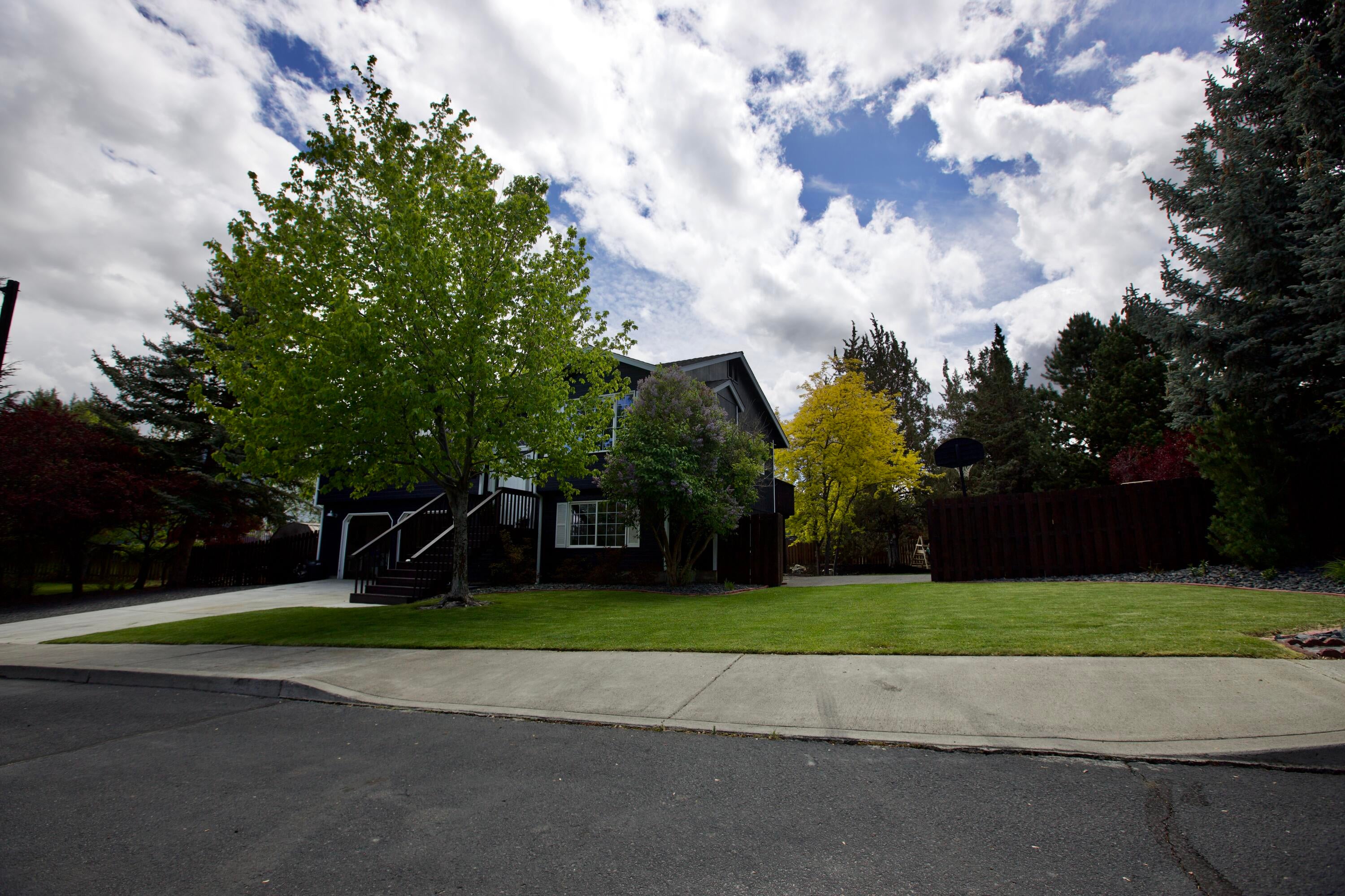 3608 Southwest Volcano Court Redmond, OR 97756 - Photo 41 of 47 street view of backyard access through double gate. Sidewalk is cutout for driveway.