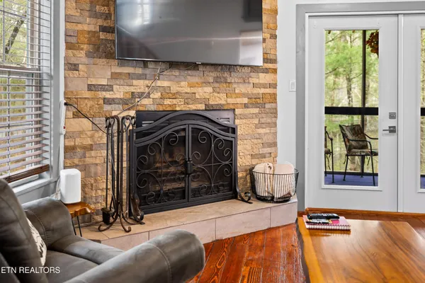 a living room with stainless steel appliances kitchen island granite countertop furniture and a kitchen view