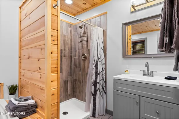 a bathroom with a tub and a window