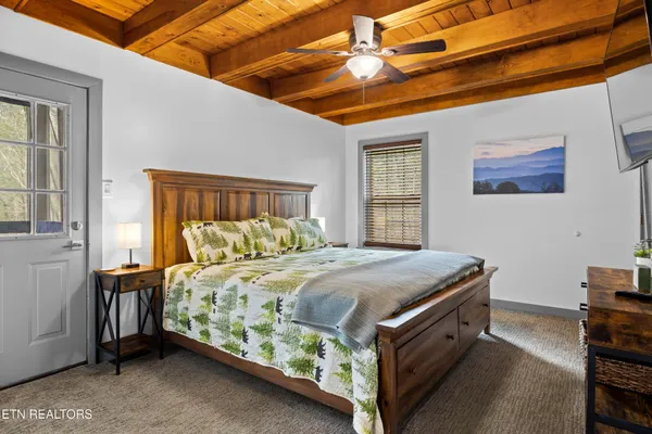 a bedroom with a bed and a flat screen tv