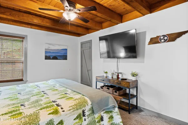 a bed sitting in a bedroom next to a window