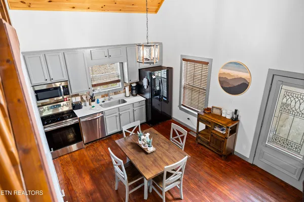 a living room with furniture and kitchen view