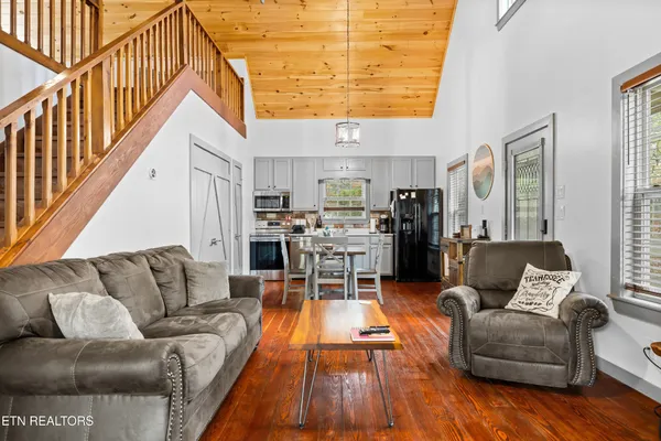 a living room with furniture and floor to ceiling windows