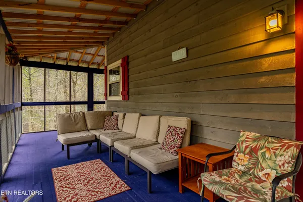 a living room with furniture and a floor to ceiling window