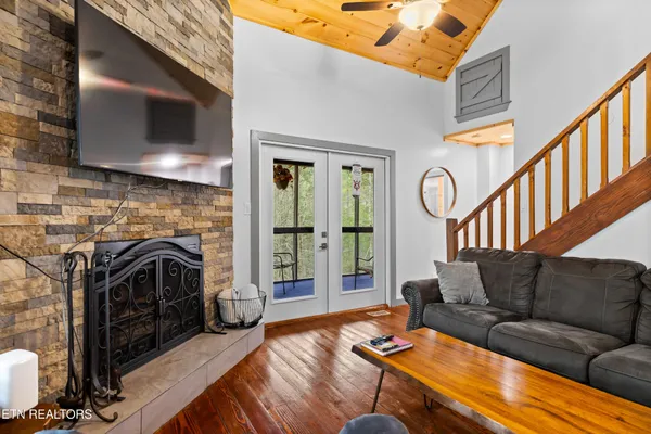 a living room with furniture a flat screen tv and a fireplace