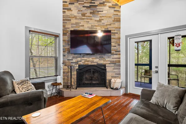 a kitchen with a dining table chairs appliances and cabinets
