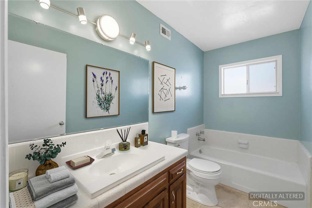 2234 Carter Way Hanford, CA 93230 - Photo 11 of 22 a bath room with a toilet a sink and a bath tub