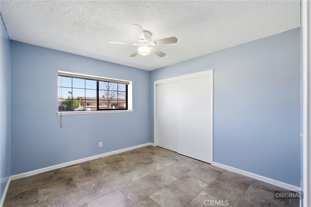 2234 Carter Way Hanford, CA 93230 - Photo 16 of 22 an empty room with windows and fan