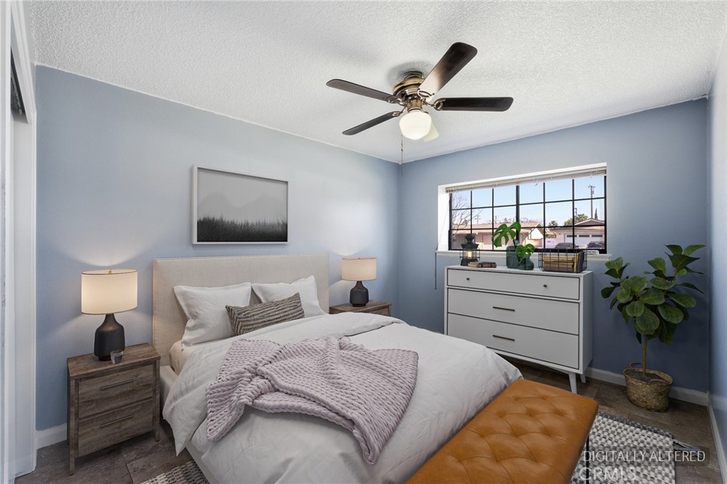 2234 Carter Way Hanford, CA 93230 - Photo 17 of 22 a bedroom with a large bed and a chandelier