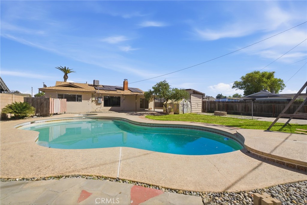 2234 Carter Way Hanford, CA 93230 - Photo 3 of 22 a view of a swimming pool with a yard