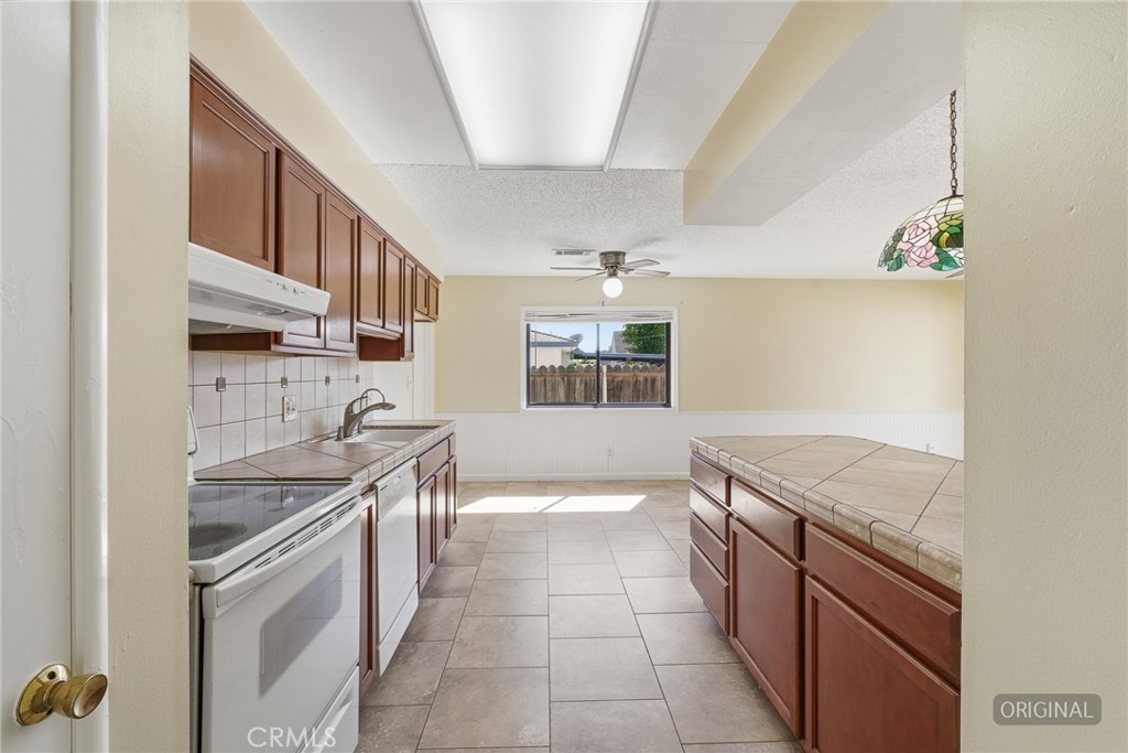 2234 Carter Way Hanford, CA 93230 - Photo 9 of 22 a kitchen with stainless steel appliances granite countertop a sink and cabinets