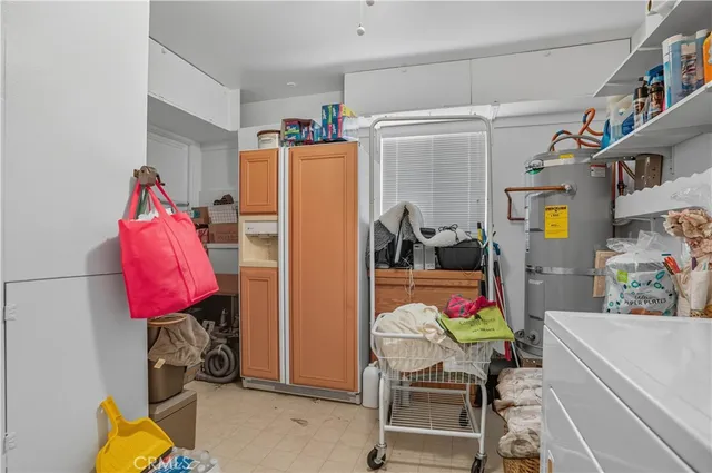 a dining room with furniture and a large window